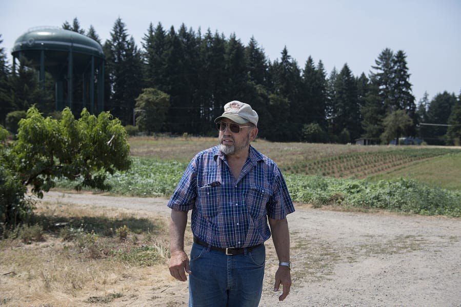 Joe’s Place Farms owner Joseph Beaudoin stands near land that he is selling to Ginn Development, which plans a subdivision of homes priced less than the county’s median.