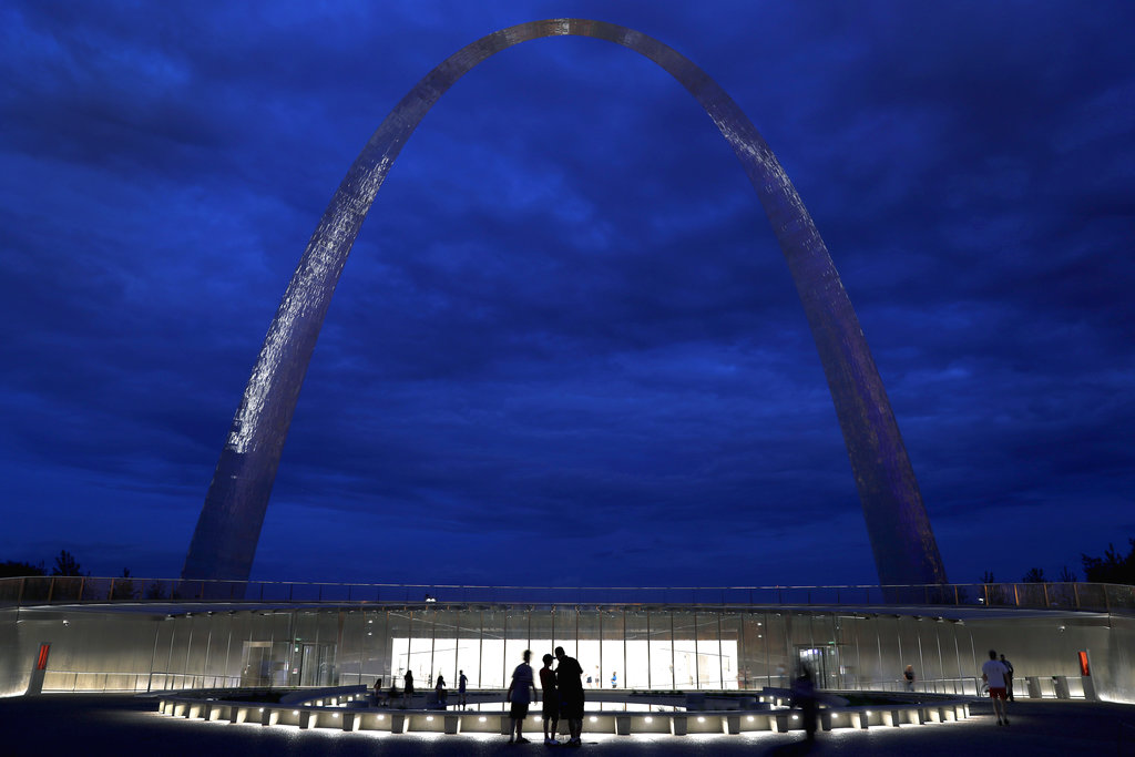 FILE - In this June 20, 2018, file photo, visitors stand outside a new entrance below the Gateway Arch in St. Louis. A newly expanded museum beneath the Arch is set to be open to the public on July 3 and is the final piece of a massive $380 million renovation of the grounds surrounding and entrance to the iconic monument.