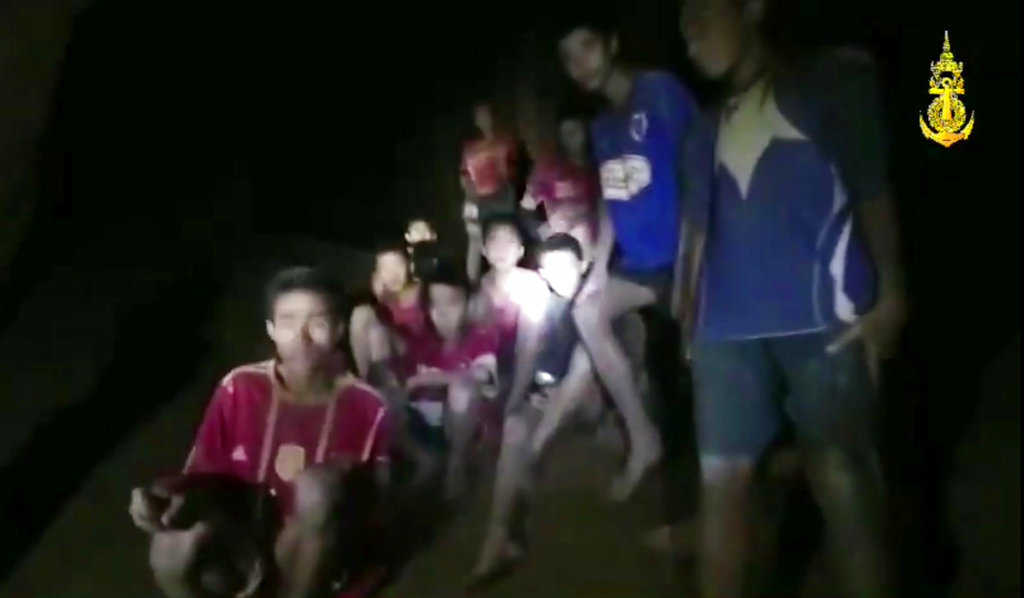 In this grab taken from video provided by the Thai Navy Seal, a view of the boys and their soccer coach as they are rescued in a cave, in Chiang Rai in Thailand, Monday, July 2, 2018.  Rescuers found all 12 boys and their soccer coach alive deep inside a partially flooded cave in northern Thailand late Monday, more than a week after they disappeared and touched off a desperate search that drew international help and captivated the nation.