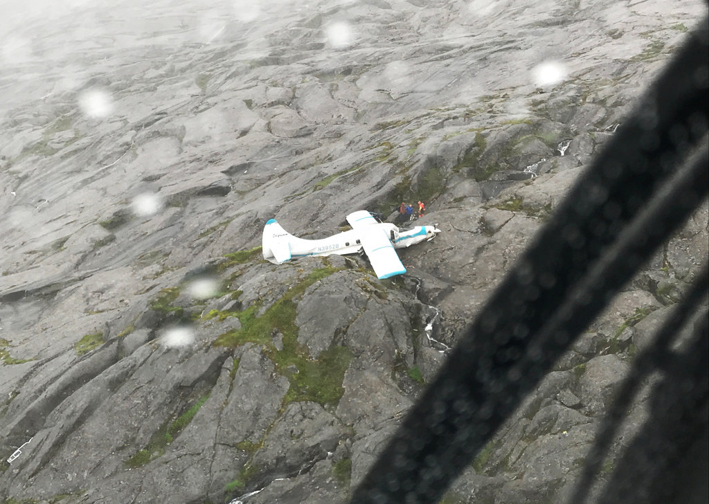 In this July 10, 2018 photo, Coast Guard Air Station Sitka MH-60 Jayhawk helicopter crews rescue people after a float plane crashed southwest of Ketchikan, Alaska, on Prince of Wales Island. All the people aboard a plane that crashed Tuesday have been rescued in mountainous terrain, officials said. (U.S.