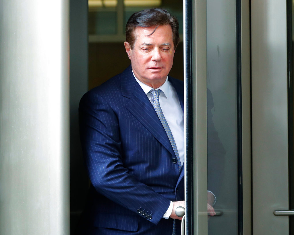 FILE - In this Feb. 14, 2018, file photo, Paul Manafort leaves the federal courthouse in Washington. The trial of President Donald Trump’s former campaign chairman will open this week with tales of lavish spending on properties and clothing and allegations that the political consultant laundered money through offshore bank accounts. What’s likely to be missing: answers about whether the Trump campaign colluded with Russia during the 2016 presidential election.