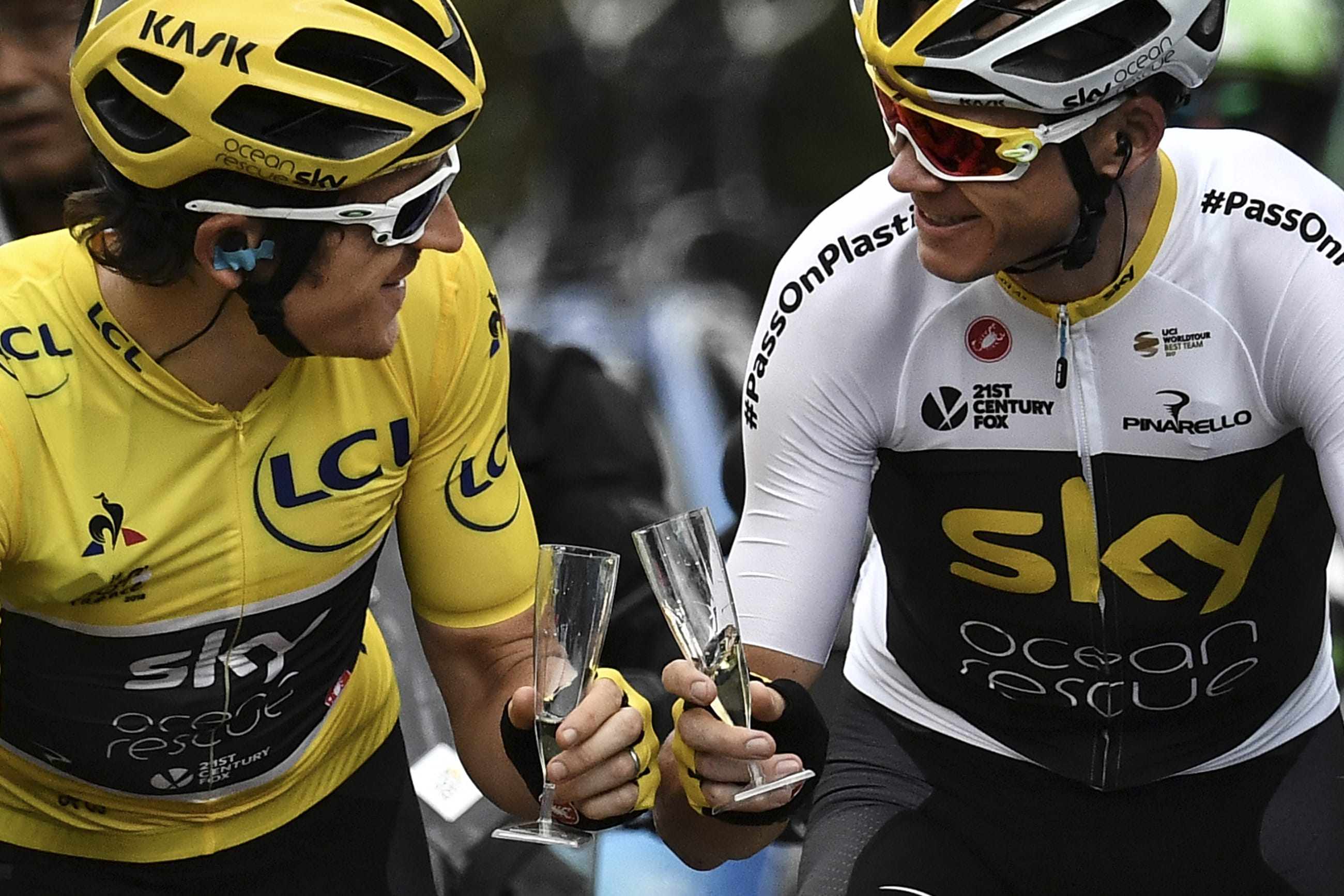 Britain's Geraint Thomas, left, wearing the overall leader's yellow jersey and Britain's Christopher Froome toast with Champagne during the 21st and last stage of the 105th edition of the Tour de France cycling race between Houilles and Paris Champs-Elysees, Sunday, July 29, 2018.