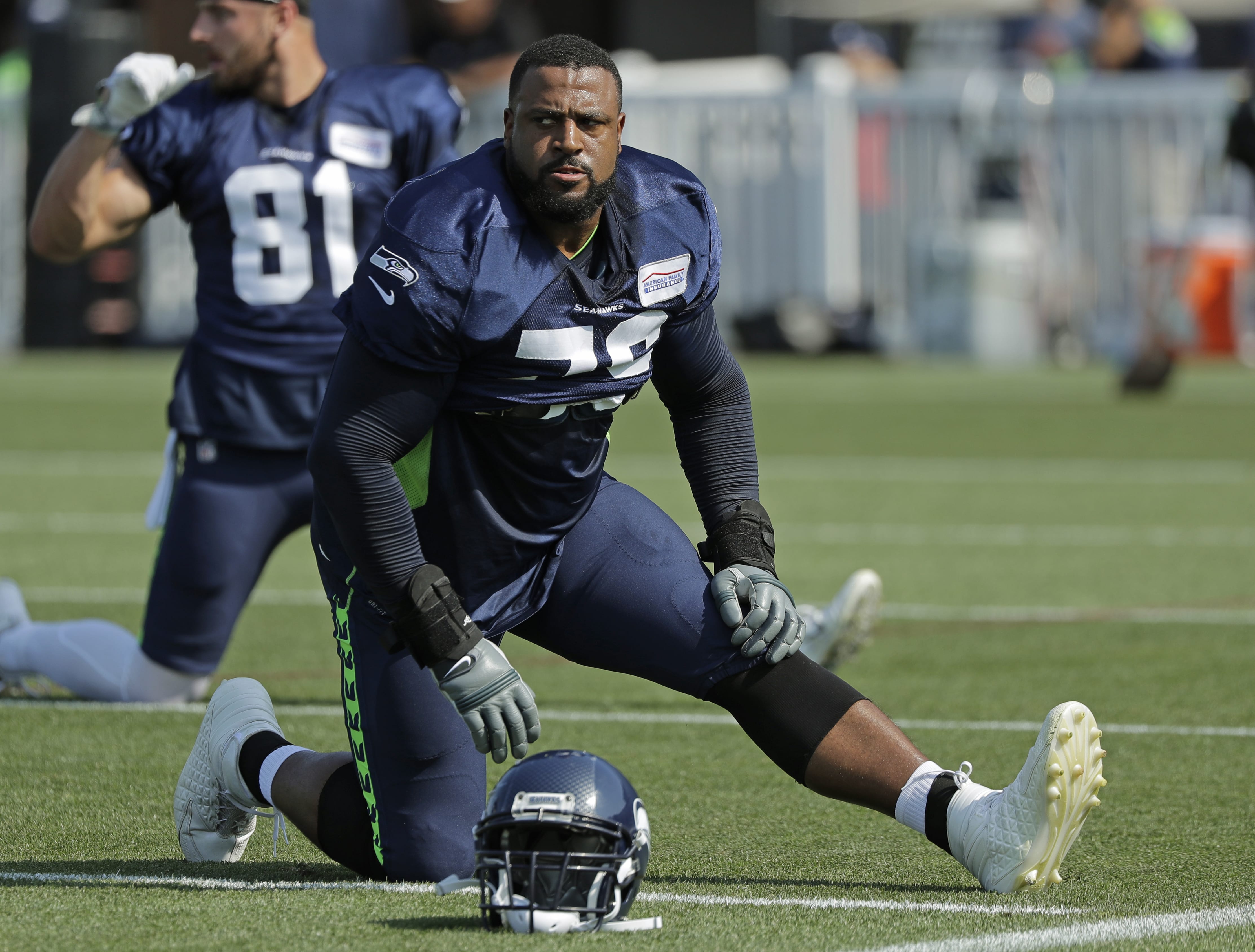 Seattle Seahawks offensive tackle Duane Brown stretches during NFL football training camp, Sunday, July 29, 2018, in Renton, Wash. (AP Photo/Ted S.
