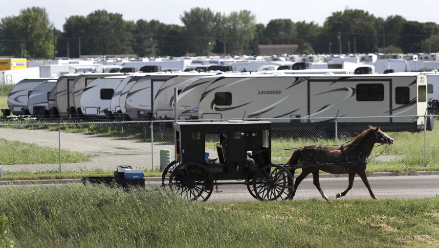An Amish family rides their horse and buggy past a storage lot for recreational vehicles in Goshen, Ind., on Friday In the county that voted nearly two-thirds for Donald Trump, a grass-roots campaign by local residents voiced enough opposition to scuttle the building of an immigration detention center nearby.