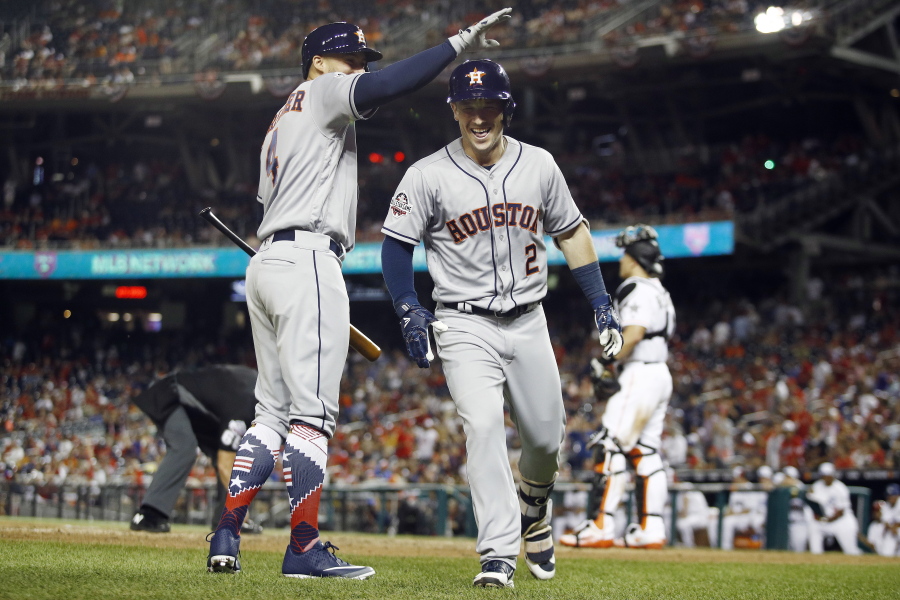 Houston Astros George Springer (4) congratulates Houston Astros Alex Bregman (2) on Bregman’s solo home run during the tenth inning at the Major League Baseball All-star Game, Tuesday, July 17, 2018 in Washington.