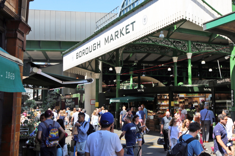 People visit Borough Market in London on Wednesday. Seven historic food and drink markets are creating an alliance to promote the sale of local produce.