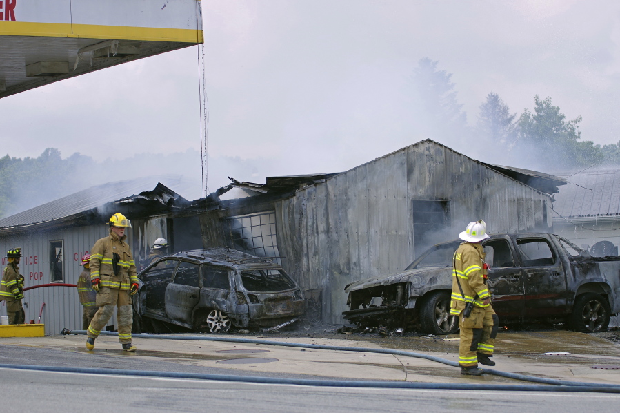 Firefighters work to put out a fire at Pikel’s Top Tier Fuels in Rayne, Pa. Authorities say a drunk driver crashed into a pump at the Pennsylvania gas station, sparking a fire that killed an employee who became trapped inside the burning service station building.