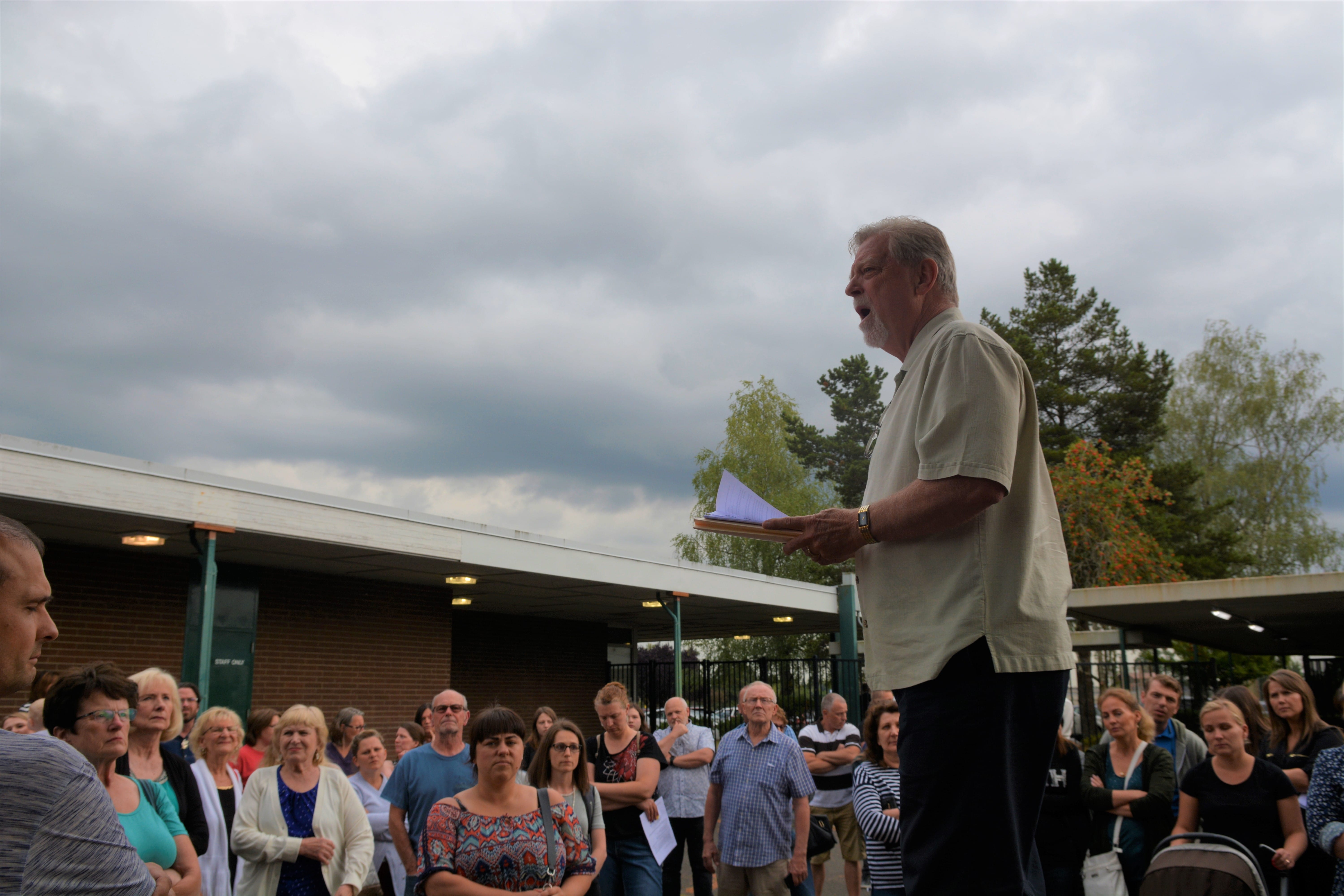 Doug Sheddy speaks to a crowd opposing the adoption of "High School FLASH" Monday at Battle Ground Public Schools. Critics of the curriculum say its lessons on gender identity and sexual orientation are not appropriate for children.