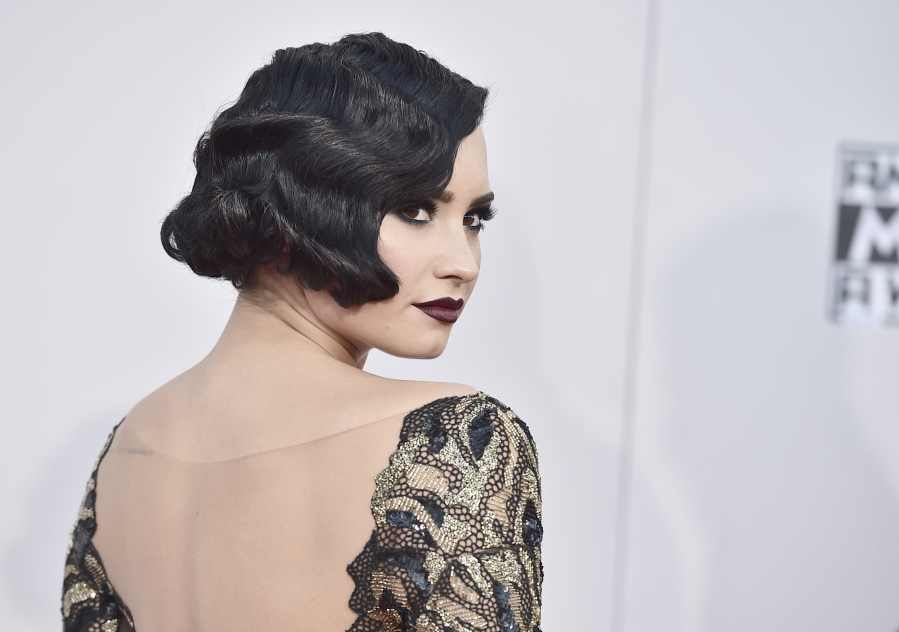 FILE - In this Nov. 22, 2015 file photo, Demi Lovato arrives at the American Music Awards in Los Angeles. Lovato has been an open book since she announced in 2010 that she was checking into a rehabilitation center to deal with an eating disorder, self-mutilation and other issues. In the next eight years, she became a role model and bona fide pop star, releasing multi-platinum songs and albums that range from playful to serious with lyrical content about her battles with drugs and alcohol. Her representative said Tuesday that the 25-year-old was awake and recovering with her family after the singer was reportedly hospitalized for an overdose.