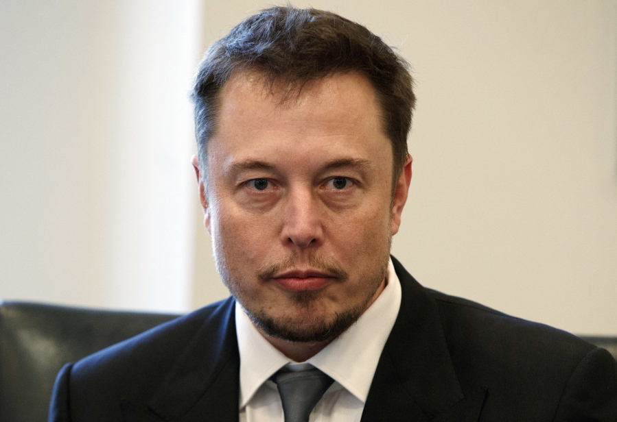Tesla CEO Elon Musk listens as President-elect Donald Trump speaks during a meeting with technology industry leaders at Trump Tower in New York. Musk has apologized for calling a British diver involved in the Thailand cave rescue a pedophile. In a series of tweets late Tuesday, the Tesla CEO said he had “spoken in anger” on Sunday after diver Vern Unsworth accused Musk of orchestrating a “PR stunt” by sending a small submarine to help divers rescue the soccer players and their coach from a cave.
