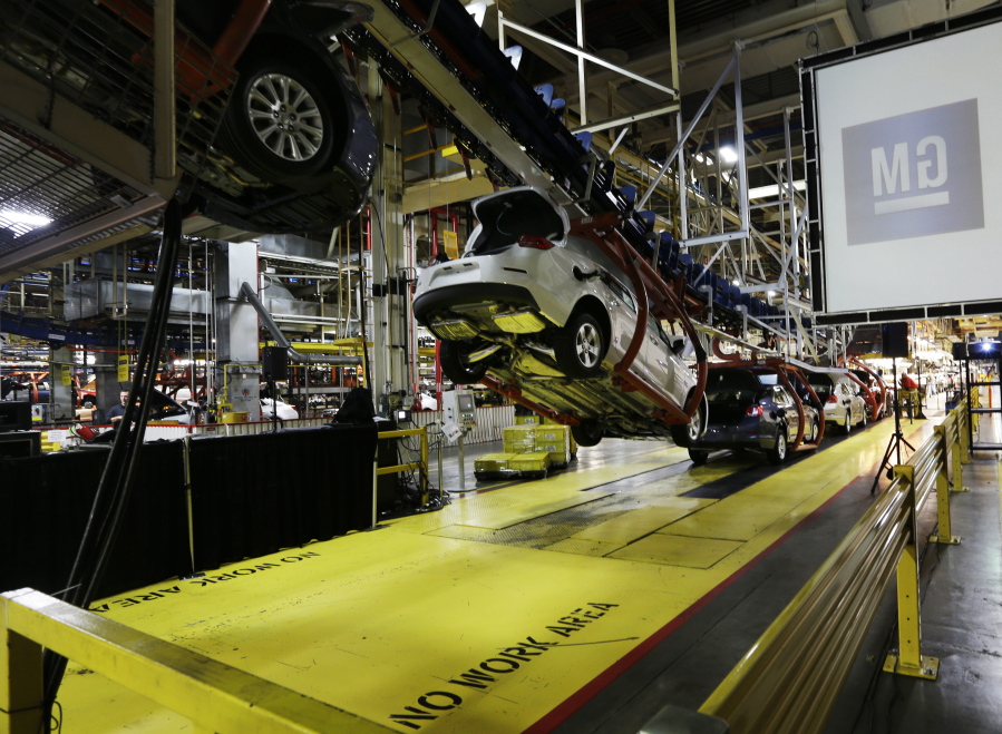 Cars move along an assembly line at the General Motors Fairfax plant in Kansas City, Kan.