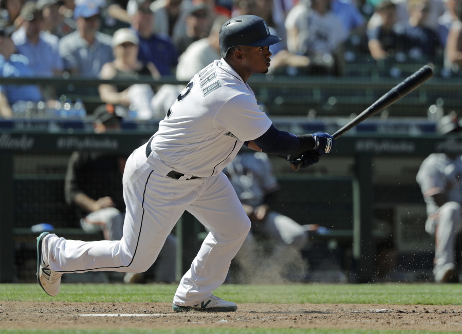 Seattle Mariners’ Jean Segura watches his tie-breaking RBI single during the eighth inning of a baseball game against the San Francisco Giants, Wednesday, July 25, 2018, in Seattle. The Mariners won 3-2. (AP Photo/Ted S.
