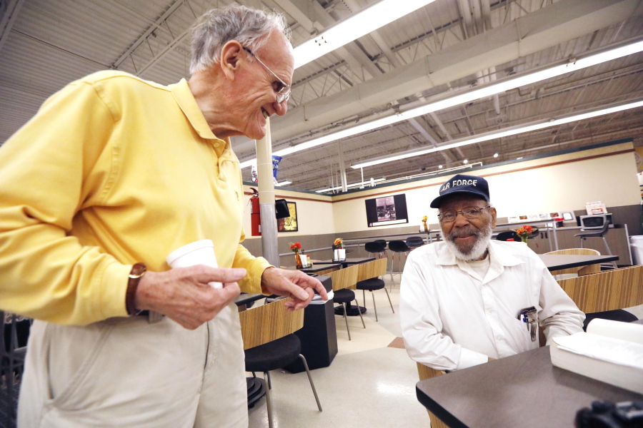 Civil rights activist James Meredith, right, takes a coffee break at a north Jackson, Miss., grocery store, Thursday, July 19, 2018, and speaks to friend Bob Litro. Meredith’s latest plan to action, “a mission from God” involves him visiting all 82 Mississippi counties and preaching about following the Ten Commandments and the Golden Rule. (AP Photo/Rogelio V.
