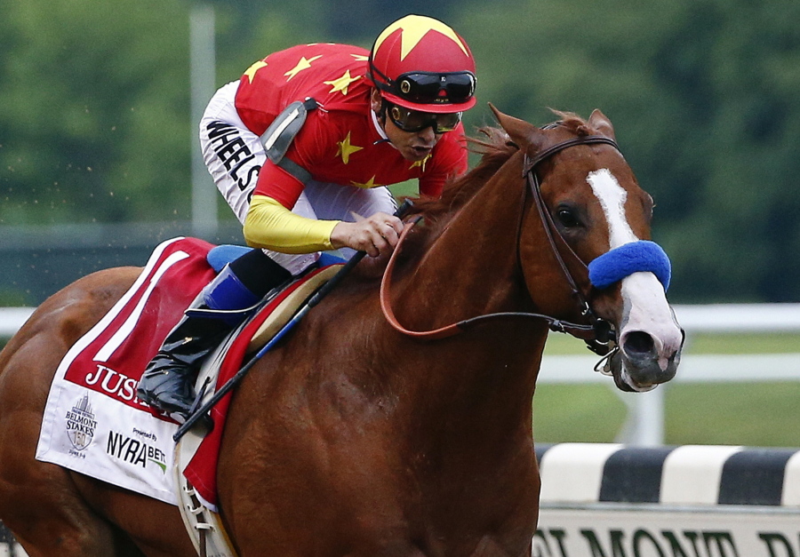 Justify, with jockey Mike Smith up, crosses the finish line to win the 150th running of the Belmont Stakes. The undefeated Triple Crown winner has been retired from racing because of fluid in his left front ankle, trainer Bob Baffert and Justify’s owners announced Wednesday, July 25, 2018.