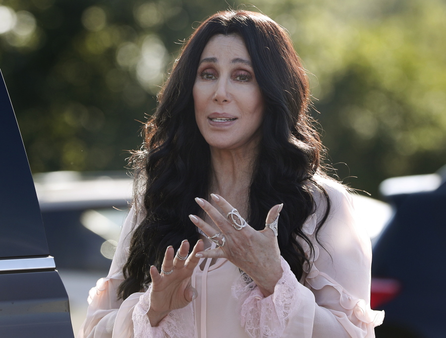 Singer and actress Cher stops to talk to media as she leaves a fundraiser for Hillary Clinton at the Pilgrim Monument and Provincetown Museum in Provincetown, Mass. Cher, composer Phillip Glass, country music star Reba McEntire and jazz legend Wayne Shorter have been announced as this year’s recipients of the Kennedy Center Honors awards. The recipients will be honored in a special ceremony at Washington’s Kennedy Center on Dec. 2.