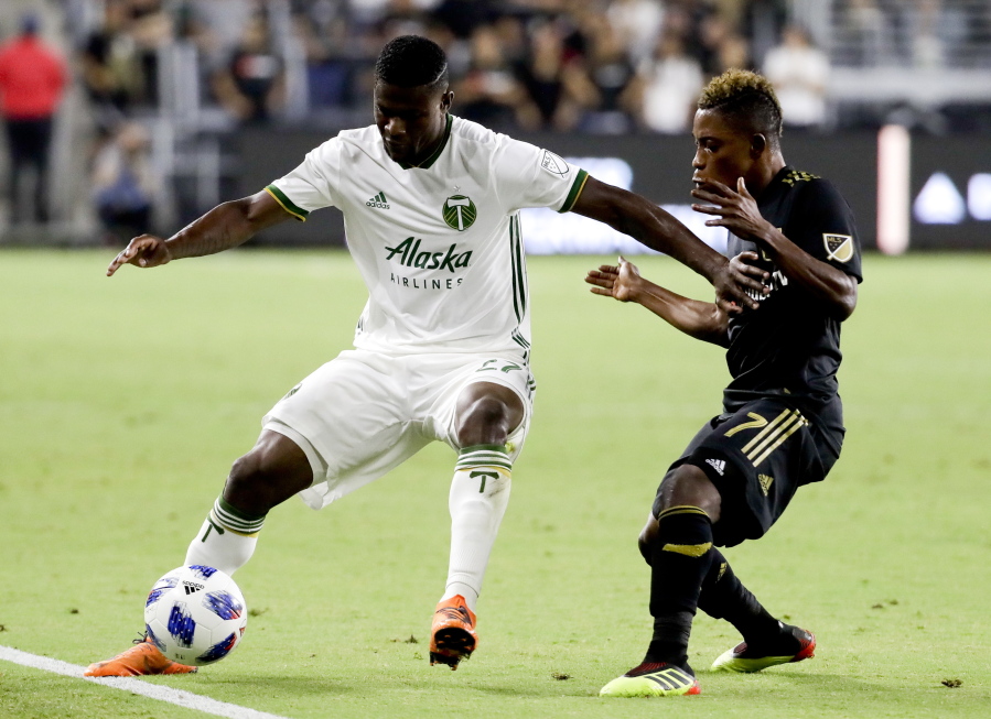 Portland Timbers forward Dairon Asprilla, left, pushes away Los Angeles FC forward Latif Blessing during the second half of an MLS soccer game in Los Angeles, Wednesday, July 18, 2018.