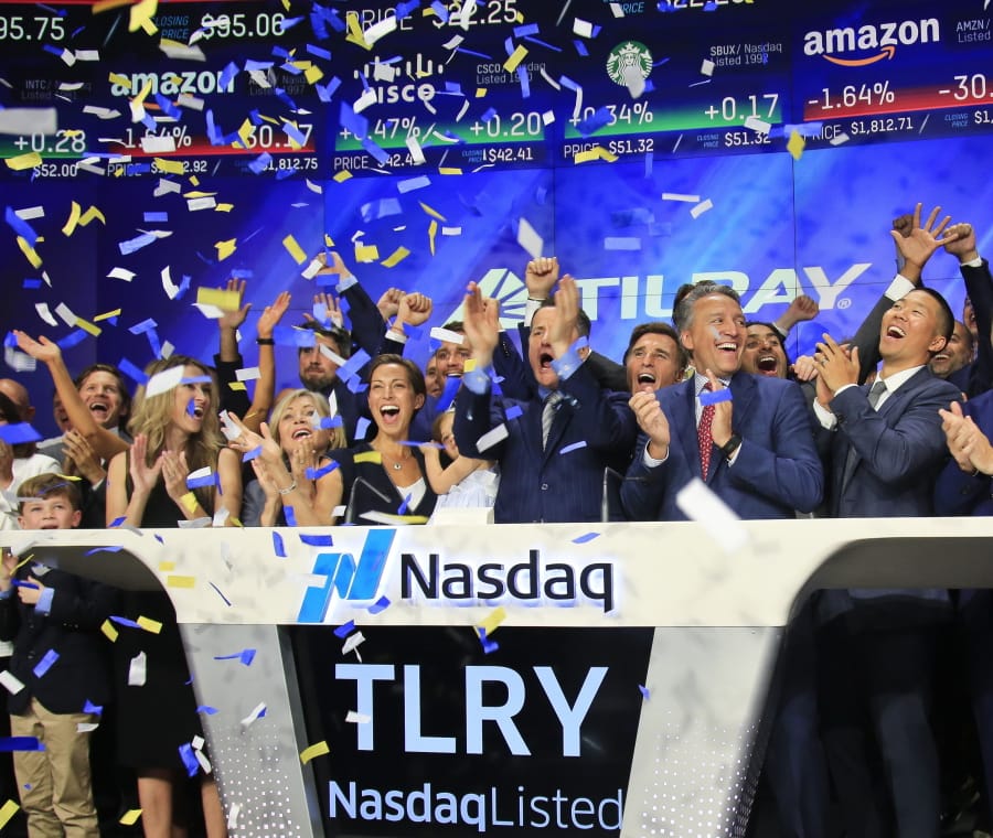 Brendan Kennedy, third from right in front, CEO and founder of British Columbia-based Tilray Inc., a major Canadian marijuana grower, leads cheers as confetti falls to celebrate his company’s IPO (TLRY) at Nasdaq, Thursday, July 19, 2018, in New York. Medical marijuana is legal in Canada, and on Oct. 17, the country will become the first major industrialized nation to legalize its production and sale for recreational use.