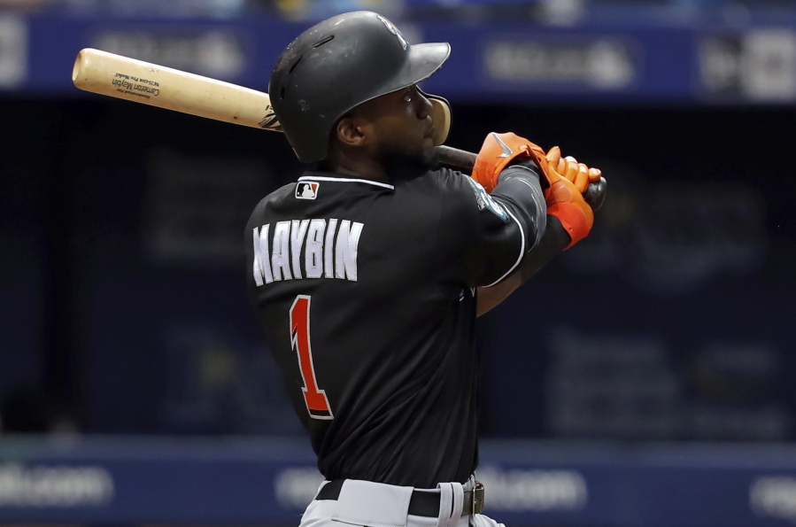 Miami Marlins' Cameron Maybin follows through on a solo home run during the seventh inning of a baseball game against the Tampa Bay Rays, Saturday, July 21, 2018, in St. Petersburg, Fla.