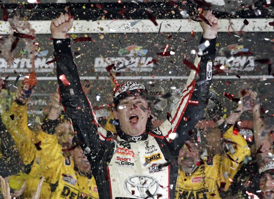 Erik Jones celebrates after winning the NASCAR Cup Series auto race at Daytona International Speedway.