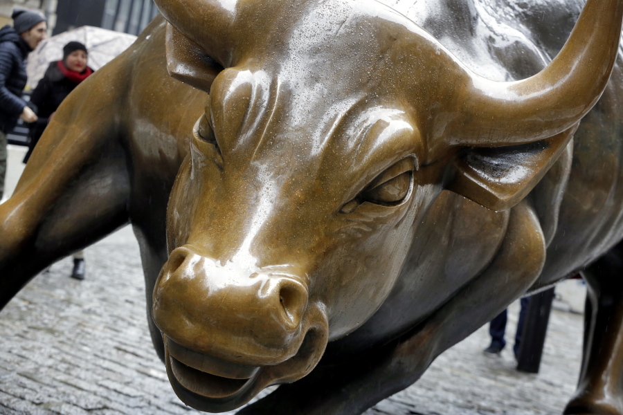 FILE - This Feb. 7, 2018 file photo shows The Charging Bull sculpture by Arturo Di Modica, in New York’s Financial District. Many along Wall Street expect the bull market rally that began in March 2009 to eclipse the 1990-2000 run that ended with the dot-com crash. But more voices are questioning whether the stock market’s run will make it beyond 2019 or 2020.