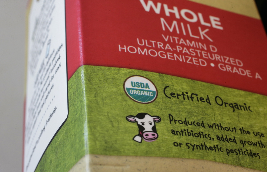 In this Monday, July 9, 2018 photo a “USDA Organic” label is printed on a milk carton in Walpole, Mass. The USDA Organic label generally signifies a product is made without synthetic pesticides and fertilizers, and that animals are raised according to certain standards. But disputes over the rules and reports of fraud may have some questioning whether the seal is worth the price.