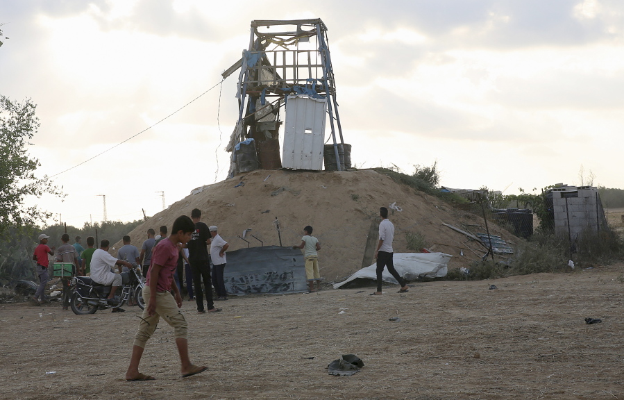 Palestinians inspect a military observation post that was hit by an Israeli tank shell east of Khan Younis, southern Gaza Strip, Friday, July 20, 2018. Israel pummeled Hamas targets in Gaza killing four Palestinians on Friday in a series of air strikes after gunmen shot at soldiers near the border, officials said. The Gaza Health Ministry said four Palestinians were killed. The militant Islamic Hamas that rules Gaza said three of the dead were members of the group.