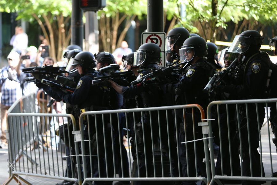 Police disperse protesters Saturday as problems occurred when two groups — Patriot Prayer and antifa — marched through the streets in Portland. Police ordered participants in a march by Patriot Prayer to leave after officers saw assaults and projectiles being thrown.