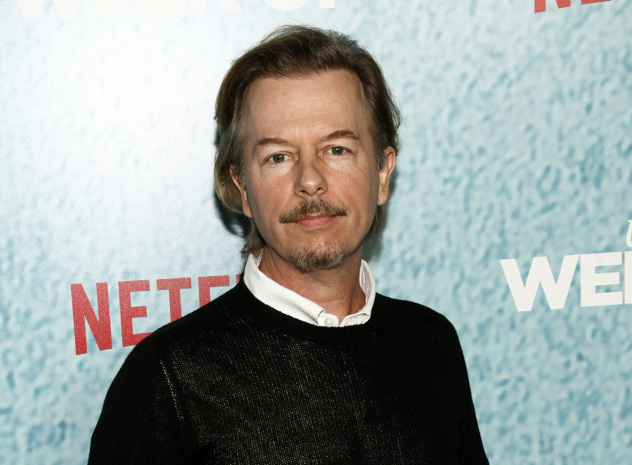 FILE - In this April 23, 2018 file photo, David Spade attends the premiere of Netflix’s “The Week Of” in New York. Spade says his family is coming together after the death of his sister-in-law Kate Spade. The fashion designer killed herself in June.