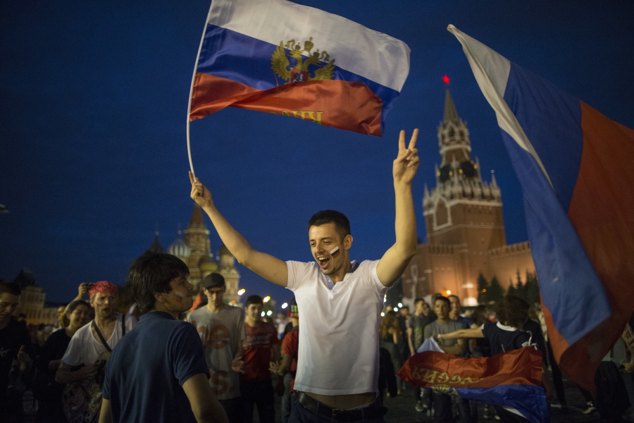 Russia soccer fans celebrate their team victory against Spain in Red Square after the round of 16 match between Spain and Russia at the 2018 soccer World Cup at the Luzhniki Stadium in Moscow, Russia, on Sunday. Russia shocks Spain at the World Cup, beating the 2010 champion 4-3 in a penalty shootout after a 1-1 draw.