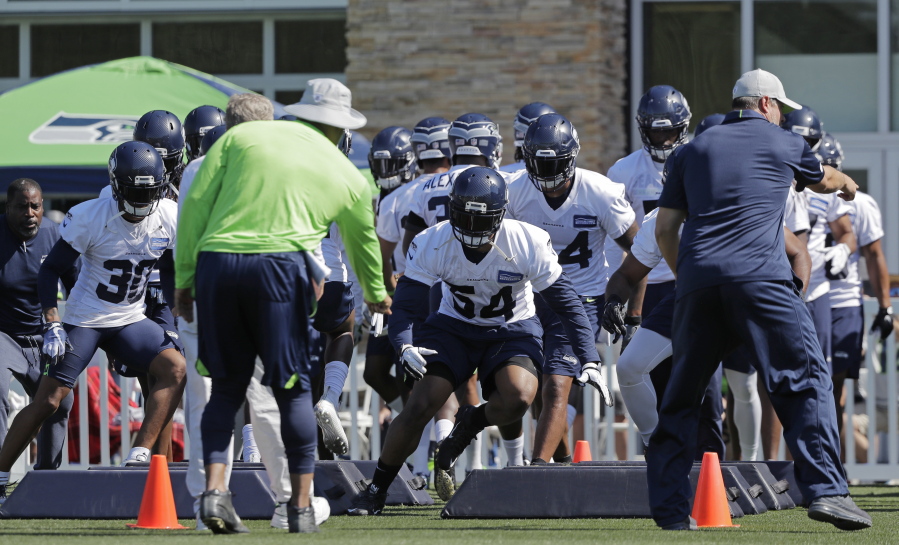 Seattle Seahawks strong safety Bradley McDougald (30) and linebacker Bobby Wagner (54) run an agility drill with teammates during NFL football training camp, Thursday, July 26, 2018, in Renton, Wash. (AP Photo/Ted S.