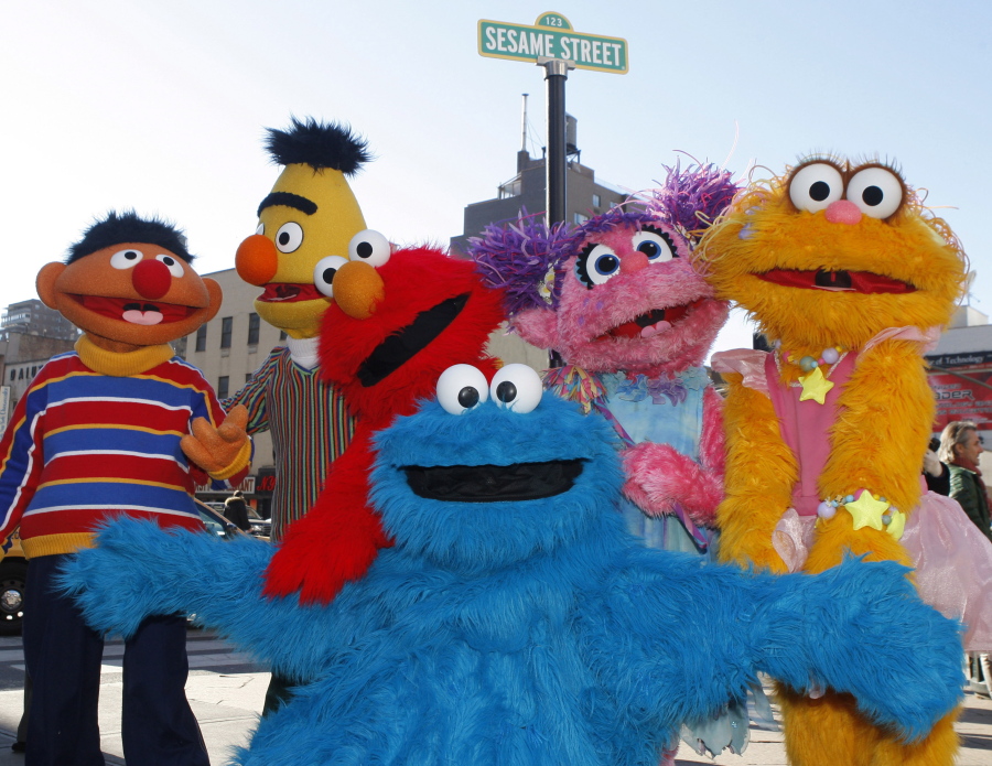 FILE - In this Feb. 10, 2010, file photo, characters from Sesame Street Live appear on the street by Madison Square Garden to celebrate the 30th anniversary of the live touring stage shows based on the PBS television series. in New York. From left are Ernie, Bert, Elmo, Cookie Monster (foreground), Abby Cadabby, and Zoe. The Sesame Street company is taking its beloved, critically-acclaimed brand of educational television into the highly profitable world of classroom curriculum. It’s a move that experts say could open the door for other companies to sink their teeth into a sacred learning space. Sesame Workshop and McGraw-Hill Education announced their new partnership Thursday, July 19, 2018.