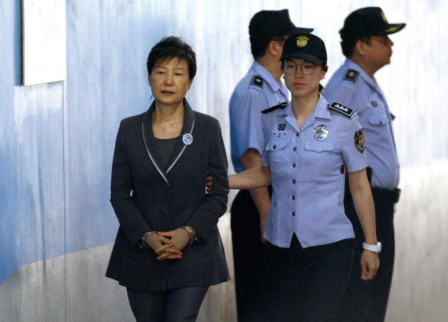 FILE - In this Aug. 7, 2017, file photo, former South Korean President Park Geun-hye, left, arrives for her trial at the Seoul Central District Court in Seoul. A South Korean court has sentenced on Friday, July 20, 2018, jailed Park to an additional eight years for abusing state funds and violating election laws.
