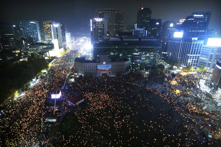 People holding candle lights stage a rally calling for South Korean President Park Geun-hye to step down in Seoul, South Korea. South Korean President Moon Jae-in’s office said Tuesday, July 10, 2018, that Moon has ordered an investigation into an allegation that the military drew up a plan to mobilize troops if protests worsened over the fate of his impeached predecessor last year.
