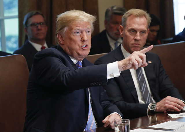 President Donald Trump gestures while speaking during his meeting with members of his cabinet in Cabinet Room of the White House in Washington, Wednesday, July 18, 2018. Looking on is Deputy Secretary of Defense Patrick Shanahan.