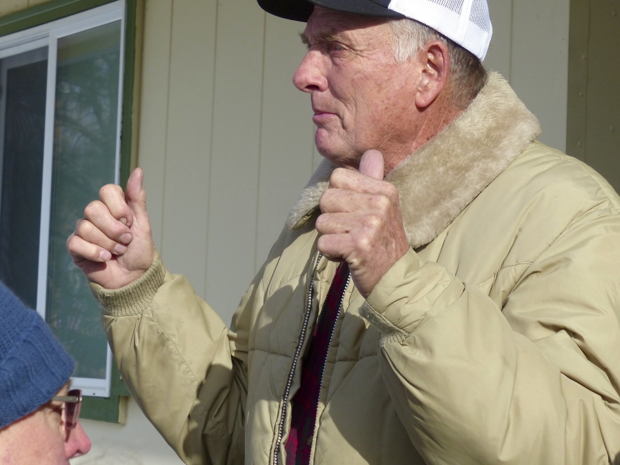 FILE - In this Jan. 2, 2016, file photo, rancher Dwight Hammond Jr. greets protesters outside his home in Burns, Ore. President Donald Trump has pardoned Dwight and Steven Hammond, two ranchers whose case sparked the armed occupation of a national wildlife refuge in Oregon. The Hammonds were convicted in 2012 of intentionally and maliciously setting fires on public lands.
