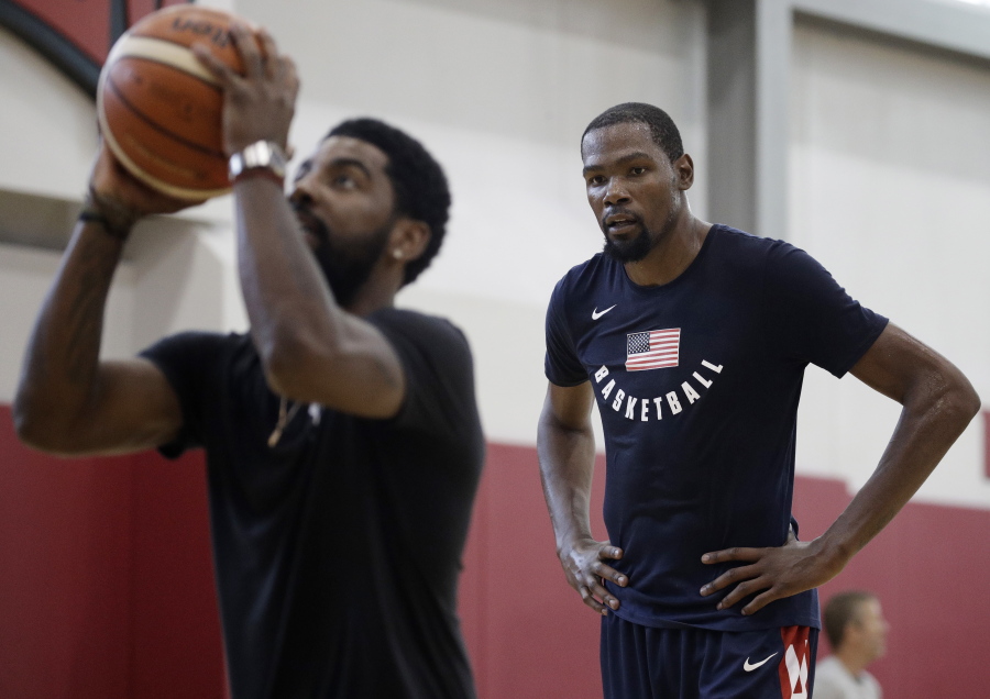 Kevin Durant, right, watches Kyrie Irving during a training camp for USA Basketball, Thursday, July 26, 2018, in Las Vegas.