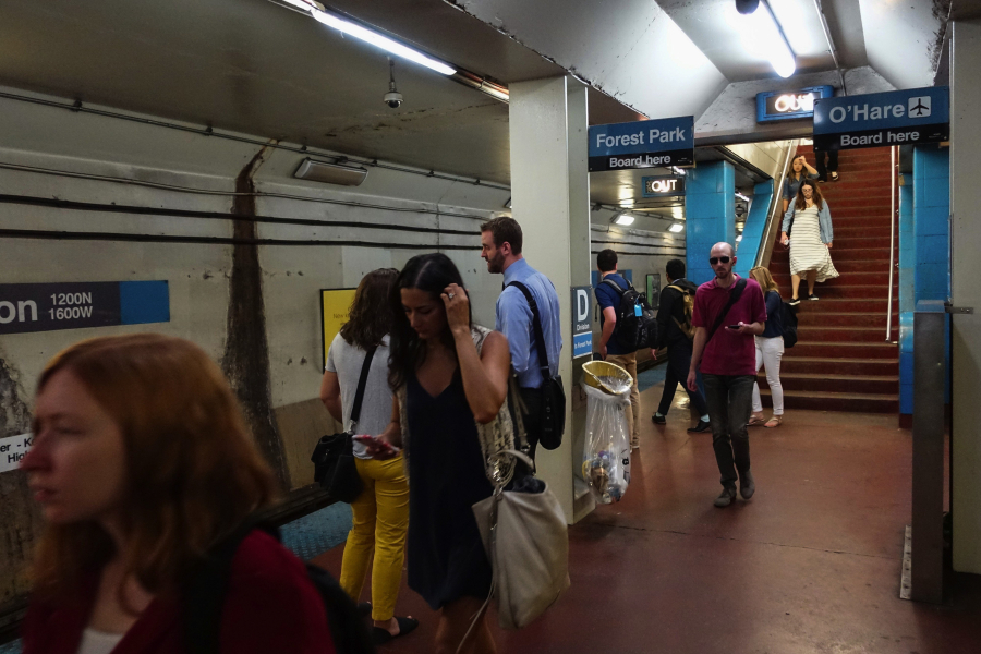 Commuters in the CTA Blue Line station platform at Chicago Avenue on July 18 in Chicago. Jose M.