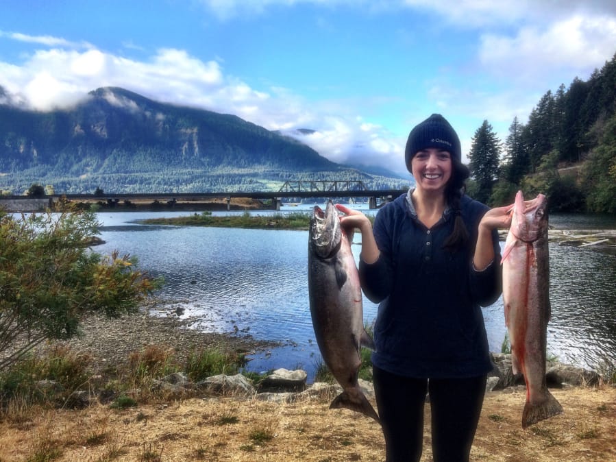 Stanca Olean shows off a fall chinook and a steelhead she caught at the mouth of the Wind River last year in better times. Steelhead retention has been closed at Drano Lake and the Wind River to protect low runs of wild fish.