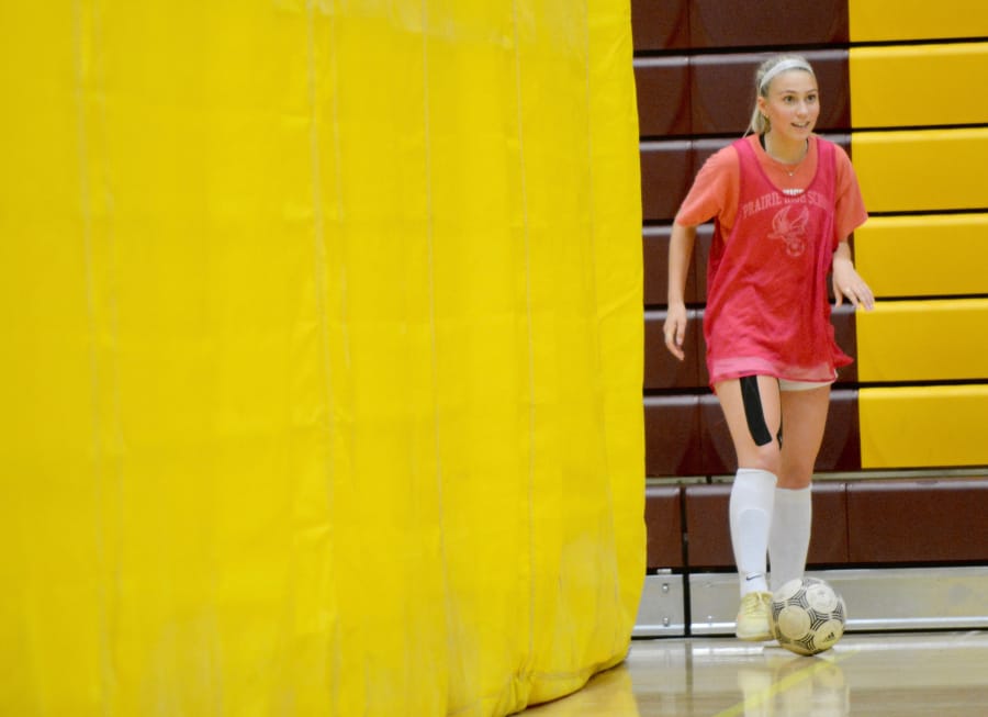 Prairie girls soccer senior Savannah Harshbarger redies to play a ball during the Falcons’ tryouts on Tuesday, Aug. 21, 2018 in Prairie High School’s basketball gym. The team practices indoors due to subpar air quality.