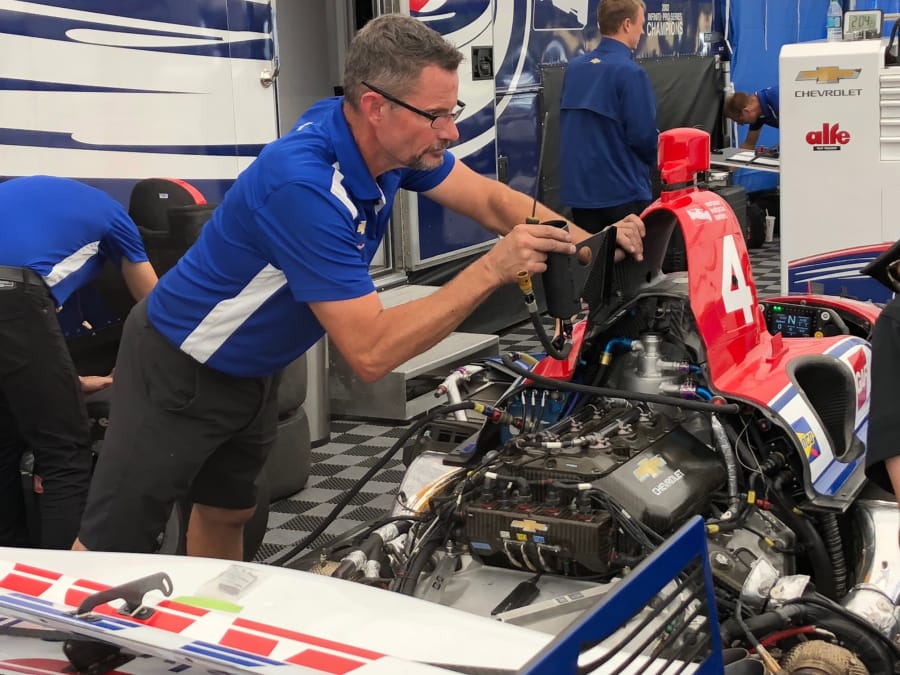 Pat Jordan, a mechanic for A.J. Foyt Racing, works on the No. 4 car driven by Matt Leist on Wednesday.