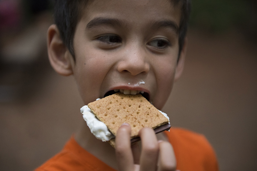 Zakary Pousson, 6, of Scappoose, Ore., dives into a gooey s’more while joining friends and family members around the campfire July 17 at Battle Ground Lake State Park. Zakary said his favorite parts of camping were exploring the area, swimming in the lake and sleeping in a cozy tent.