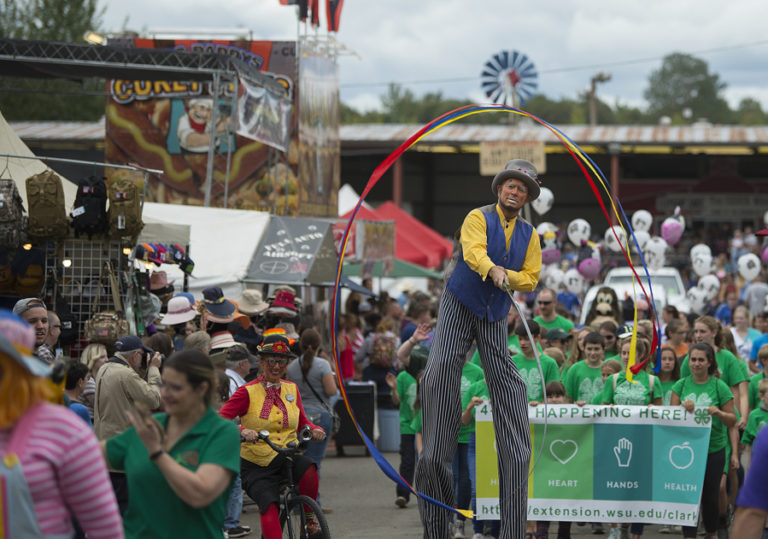 Topper Todd of Jest in Time, center, helps kick off the first day of the Clark County Fair in style while joining a parade at the fairgrounds on Friday afternoon. This year, the fair is celebrating its 150th anniversary, and more people are expected to attend as a result.