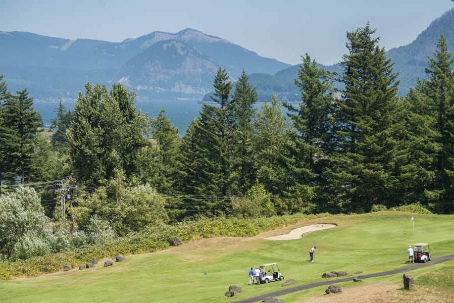 Golfers work on their putting at the Skamania Lodge Golf Course on Wednesday afternoon in Stevenson.