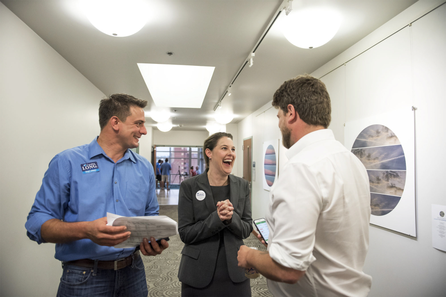 Campaign manager Wyatt Arnall, from left, Carolyn Long, Democratic candidate for the 3rd Congressional District, and campaign consultant Parker Butterworth react to the election results Tuesday night at the Clark County Public Service Center.