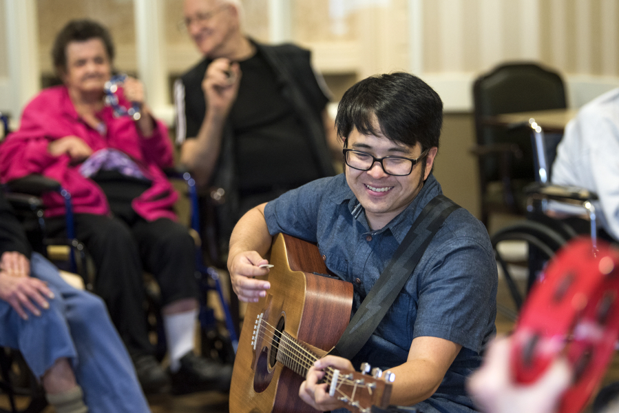 Daniel Maruyama plays “Twist and Shout” during a weekly music therapy session at The Hampton at Salmon Creek, a memory care facility in Vancouver. Research shows that performing and practicing music can help contain the effects of aging and diseases of the brain, such as dementia.
