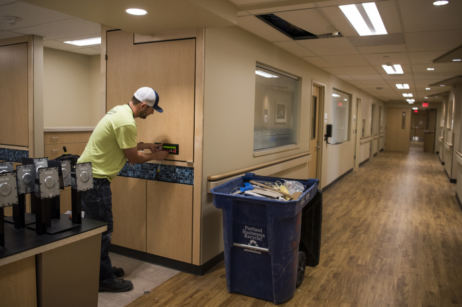 Travis Coalman with Hamer Electric installs fire alarms in the new inpatient rehab unit at PeaceHealth Southwest Medical Center, which is set to open on Aug. 27. The unit will move from the fourth floor of the Mother Joseph Building to the third floor.