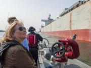 Vancouver Mayor Anne McEnerny-Ogle examines a cargo ship at the Port of Vancouver during a joint meeting of the Vancouver City Council and Port of Vancouver Board of Commissioners on board the fire boat Discovery Monday.