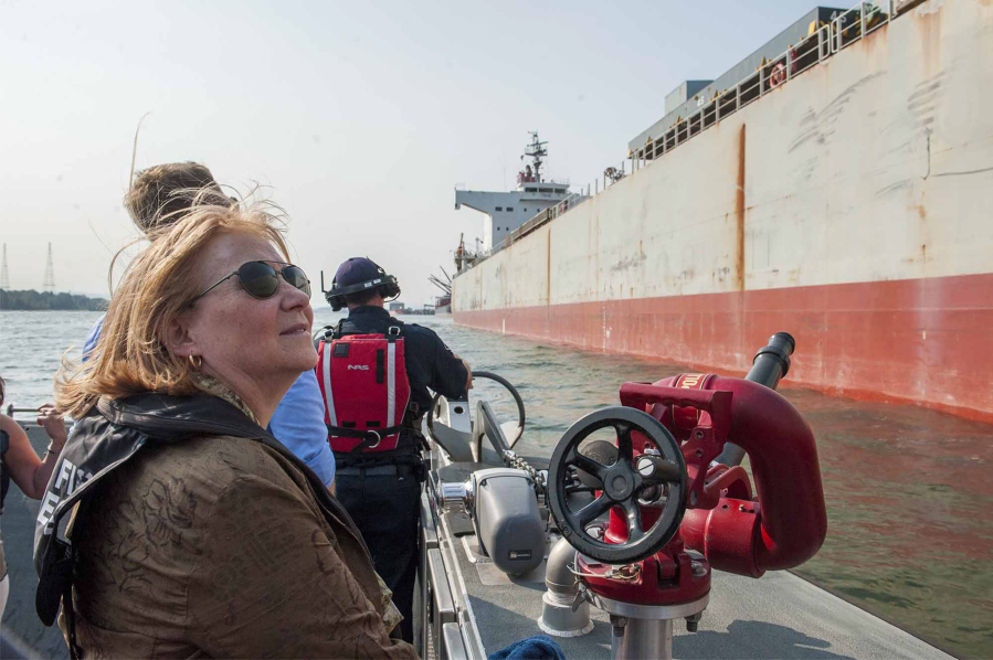 Vancouver Mayor Anne McEnerny-Ogle examines a cargo ship at the Port of Vancouver during a joint meeting of the Vancouver City Council and Port of Vancouver Board of Commissioners on board the fire boat Discovery Monday.