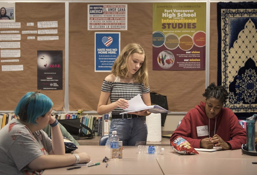 True Ware, 13, reads a story about a faded friendship while Blue Jackson, 18, at left, and Trinity Stegall, 17, listen in during a story workshop at Fort Vancouver High School. These girls are getting ready for “Girls ROAR,” a stoytelling festival set for Aug. 23 at the Kiggins Theatre in Vancouver.