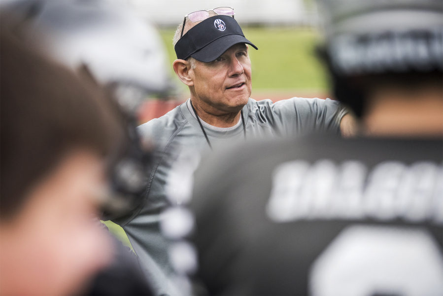 Mark Rego, Union High School assistant football coach, listens to a player during a drill at a Union practice on Thursday afternoon, Aug. 23, 2018.